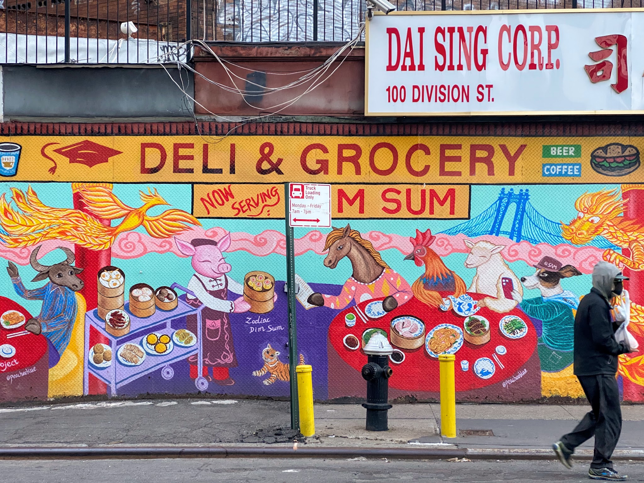 Colorful hand-painted mural in Manhattan Chinatown depicting various animals in the Chinese zodiac eating dim sum